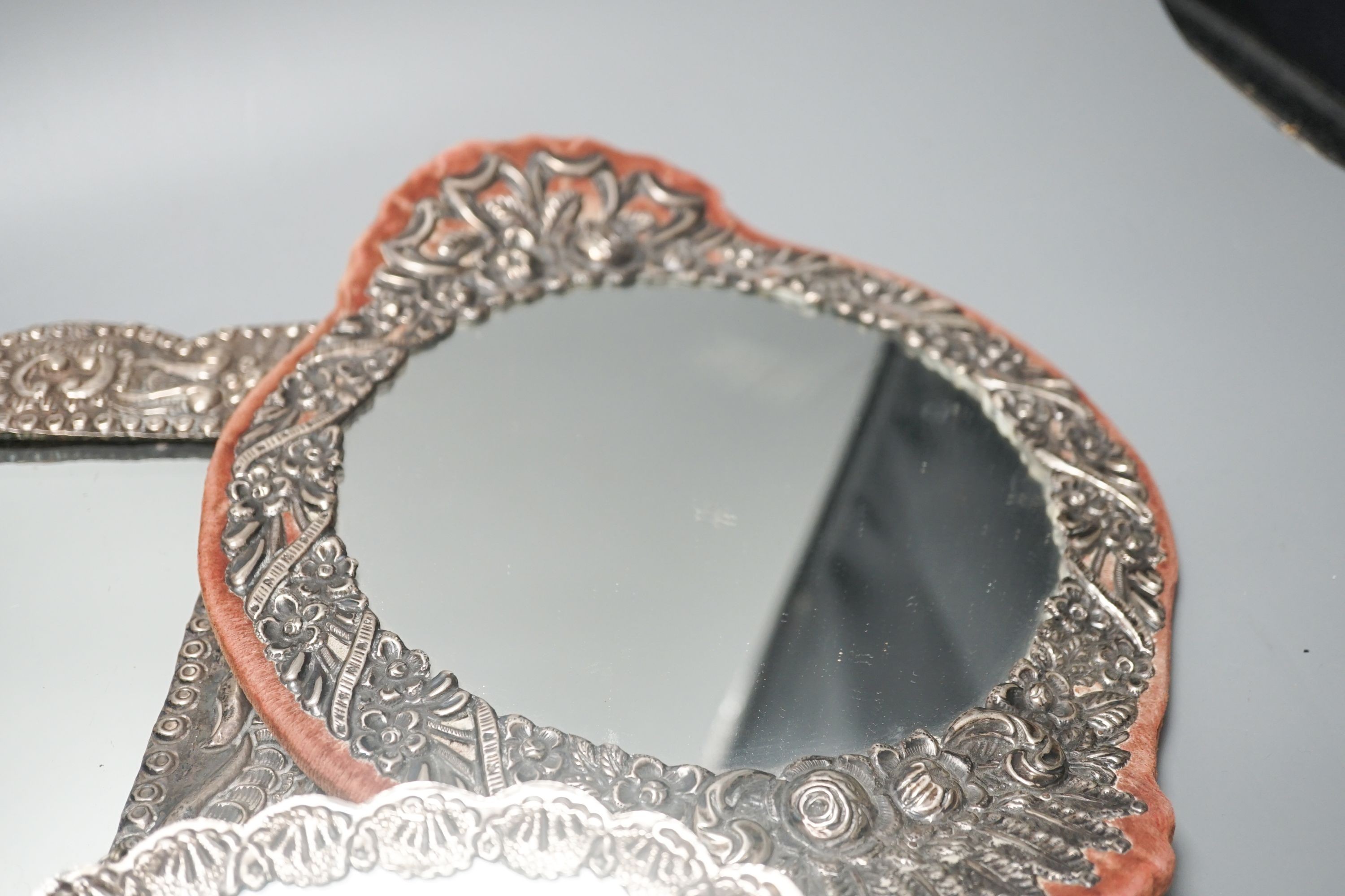 Three assorted Turkish white metal mounted mirrors, largest, 32.2cm.